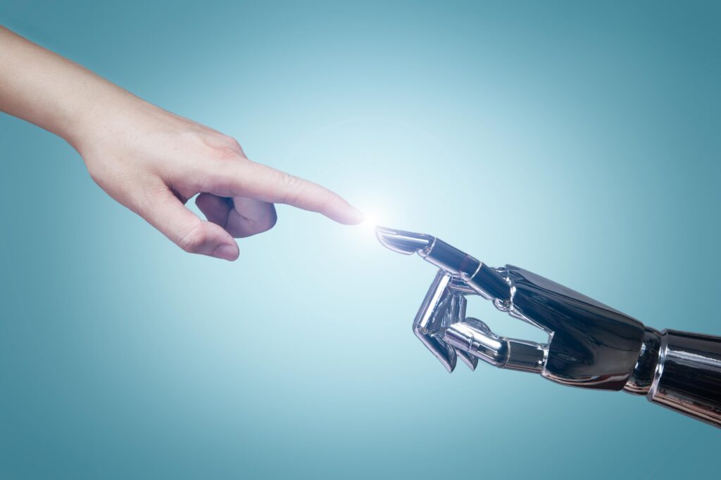 image depicting artificial intelligence with a robot hand and human hand touching at the finger tip